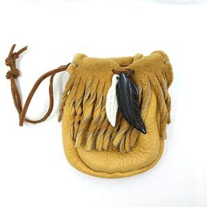 Tan leather pouch with copper beads and feathers